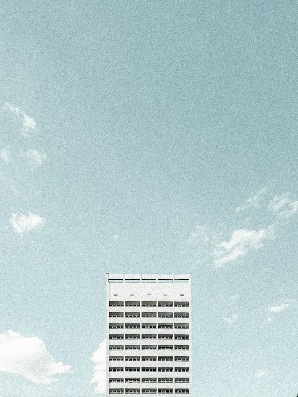 white concrete building under blue sky during daytime