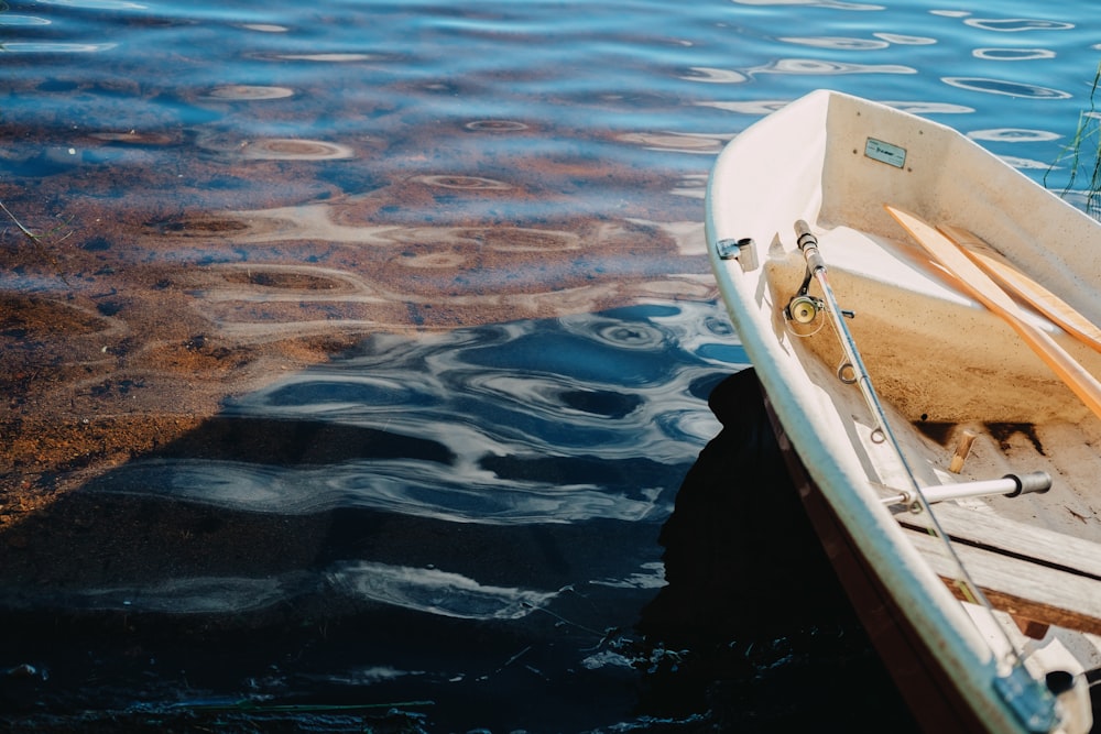 white boat on body of water during daytime