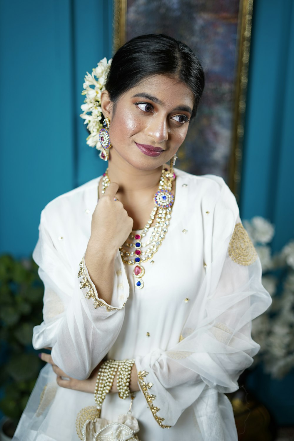 woman in white dress shirt wearing gold necklace