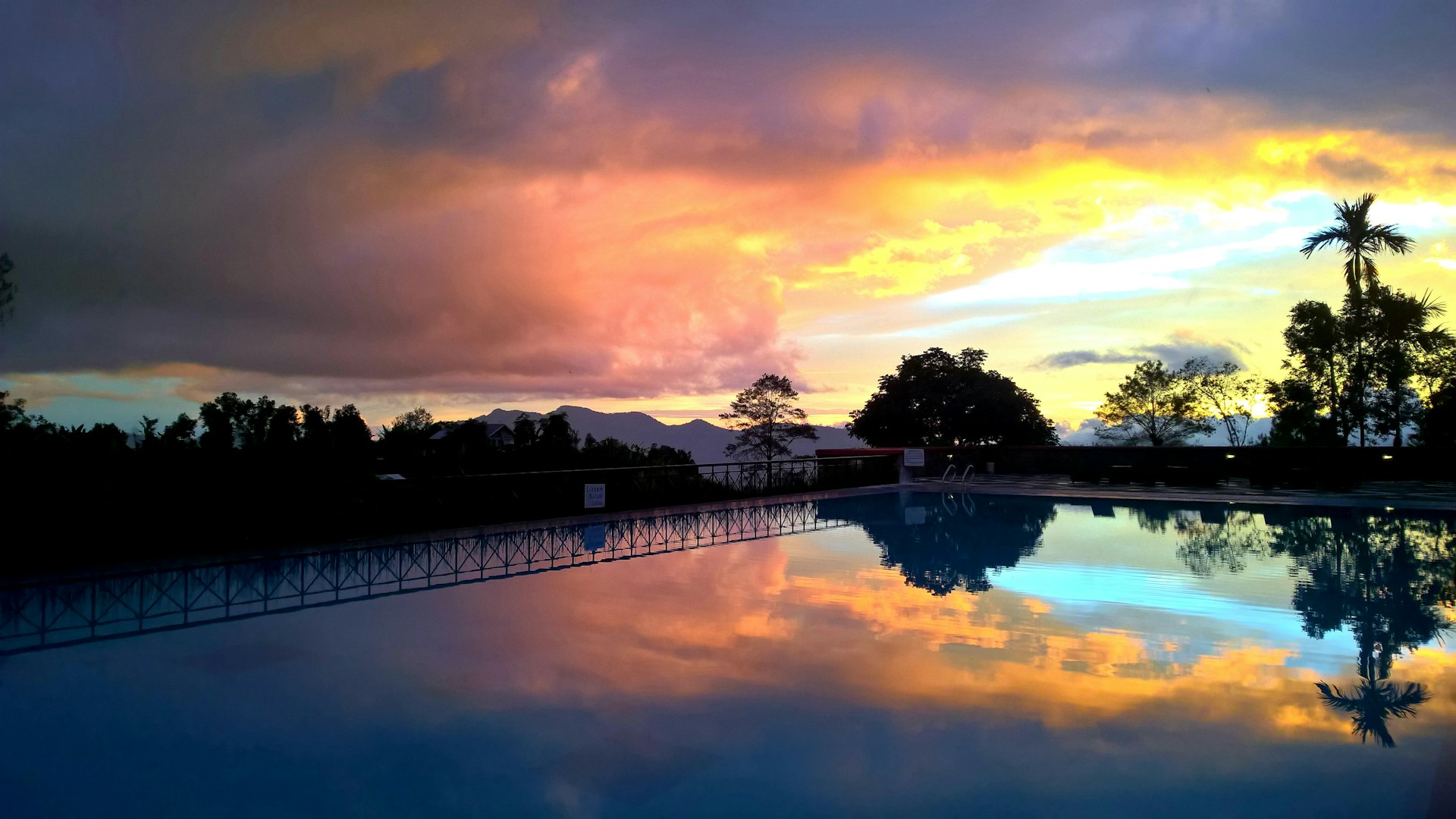 Sunset view over a private pool area at a Punta Cana rental, capturing the vibrant colors of the sky.