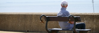 man and woman sitting on bench during daytime