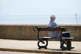 man and woman sitting on bench during daytime