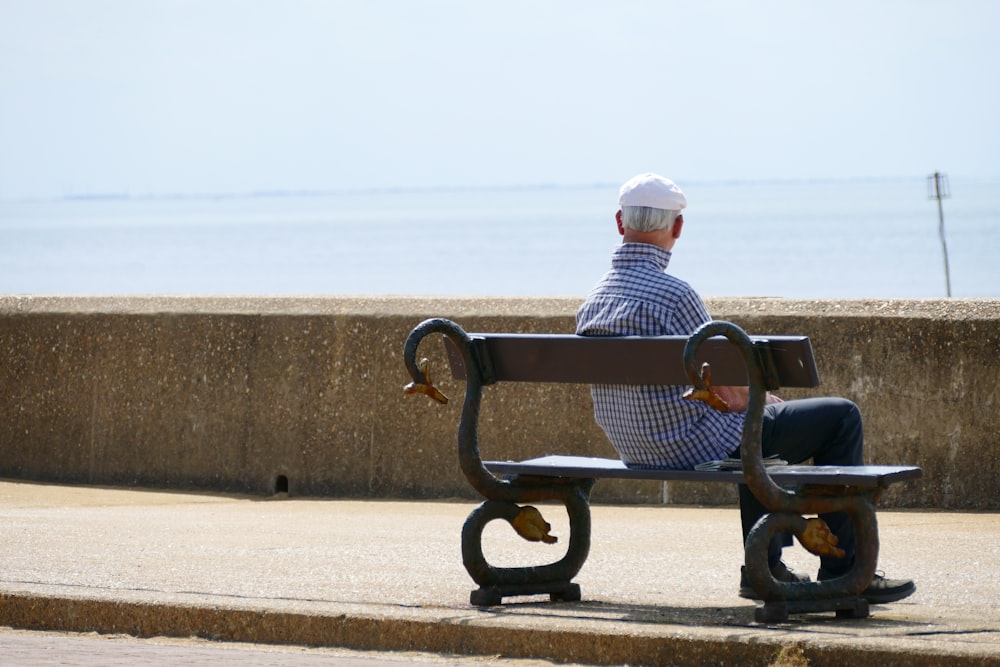 man and woman sitting on bench during daytime