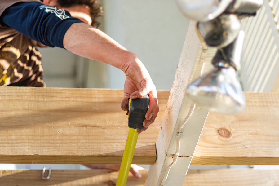 Carpenter using a power tool on interior wood trim