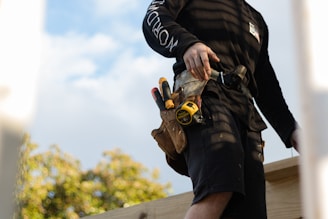 Skilled tradesman wearing tool belt ready for plumbing and building work        Ask ChatGPT