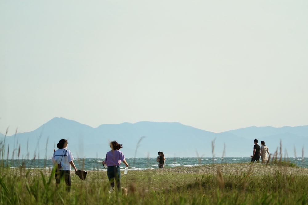 people walking on green grass field during daytime