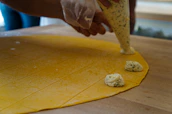 A cozy kitchen scene showing fresh raviolis being prepared with care and attention.
