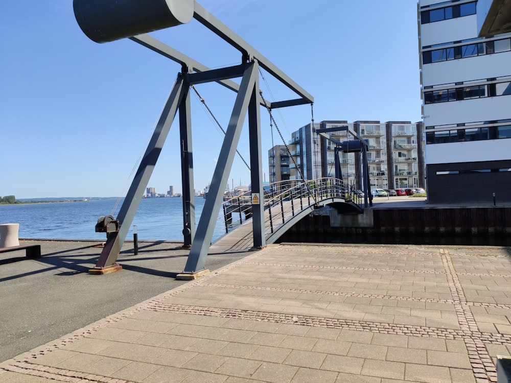 gray metal bridge on sea during daytime