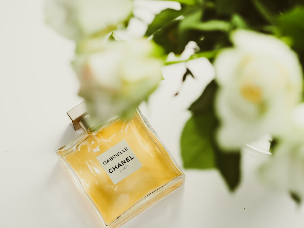 yellow glass perfume bottle on white table