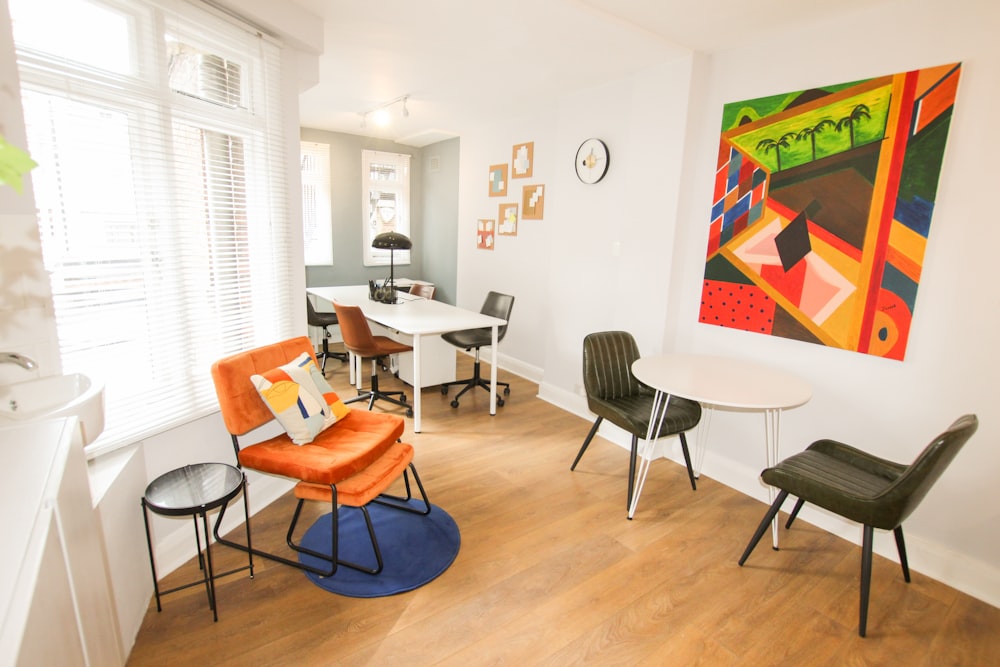 orange and black chair beside white table