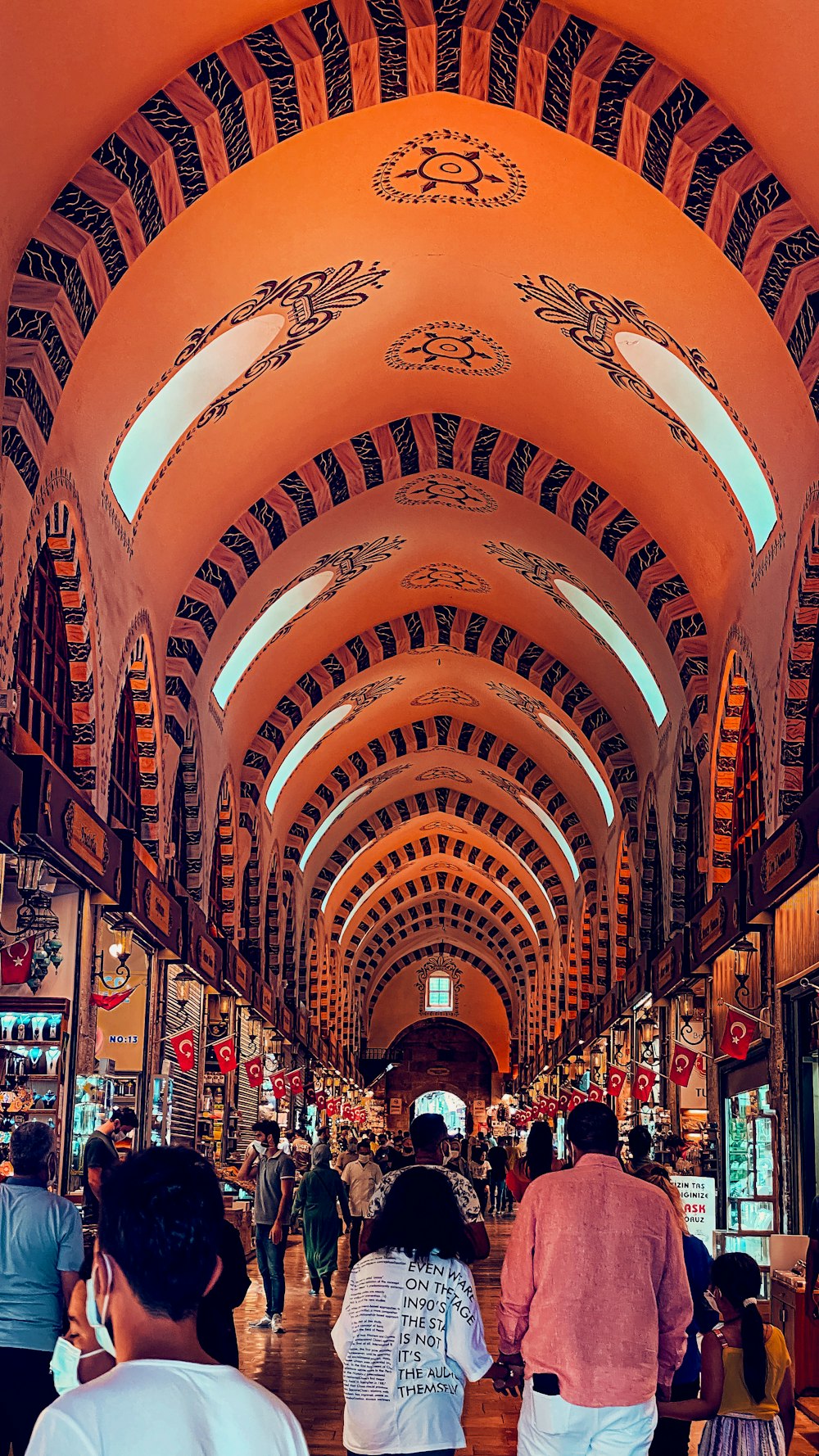 a group of people walking down a long hallway