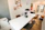 A modern office space featuring a framed art print from luckyartzstudio on the wall.