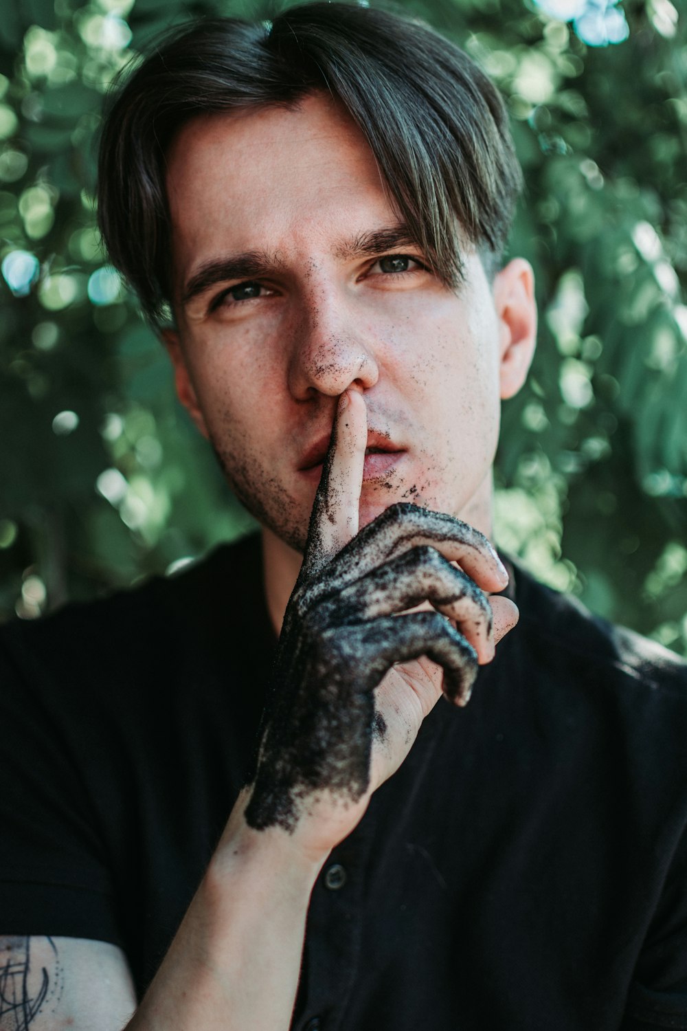 man in black crew neck shirt with black paint on his face