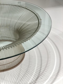 Modern steel coffee table with glass top reflecting soft natural light