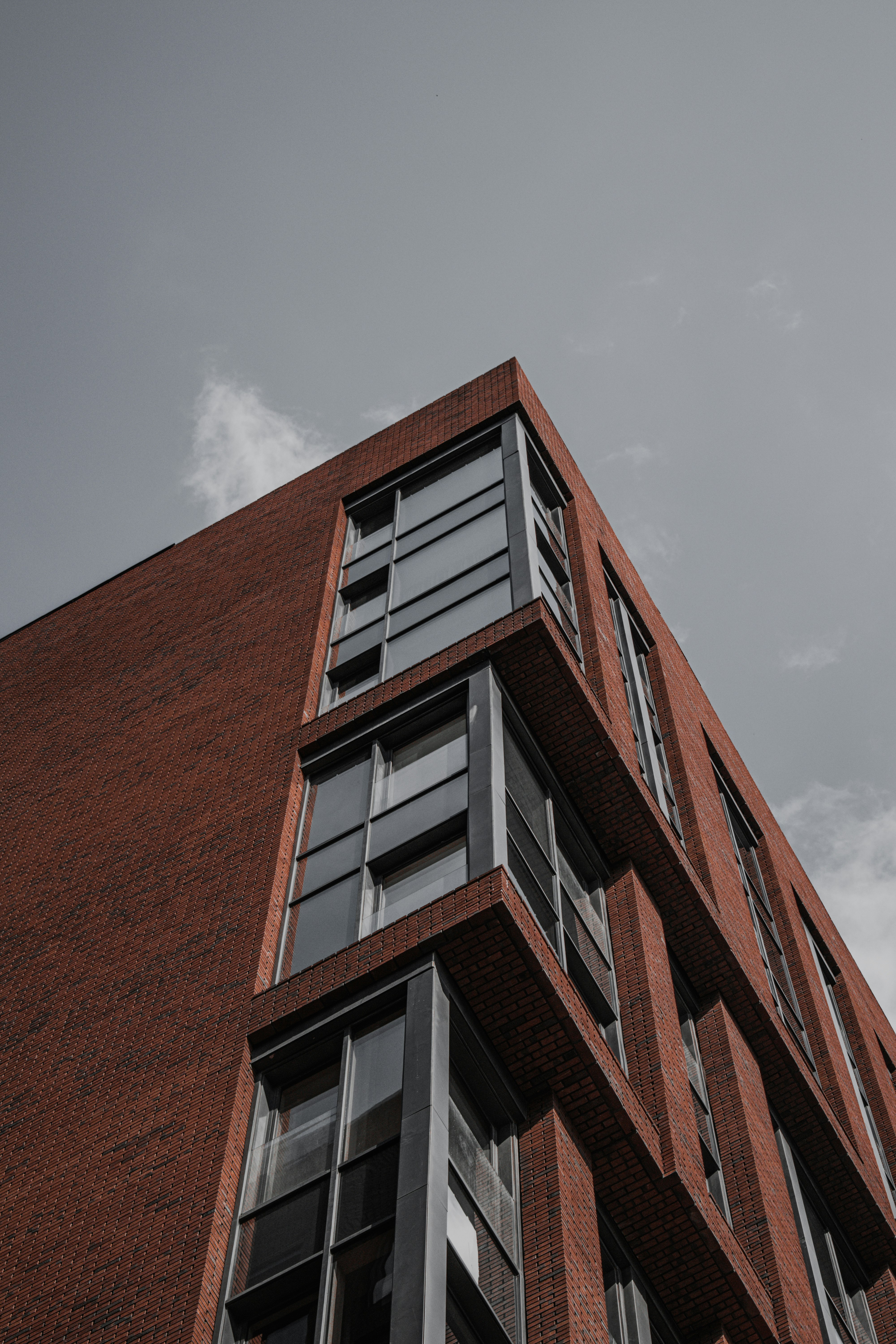 brown concrete building under gray sky