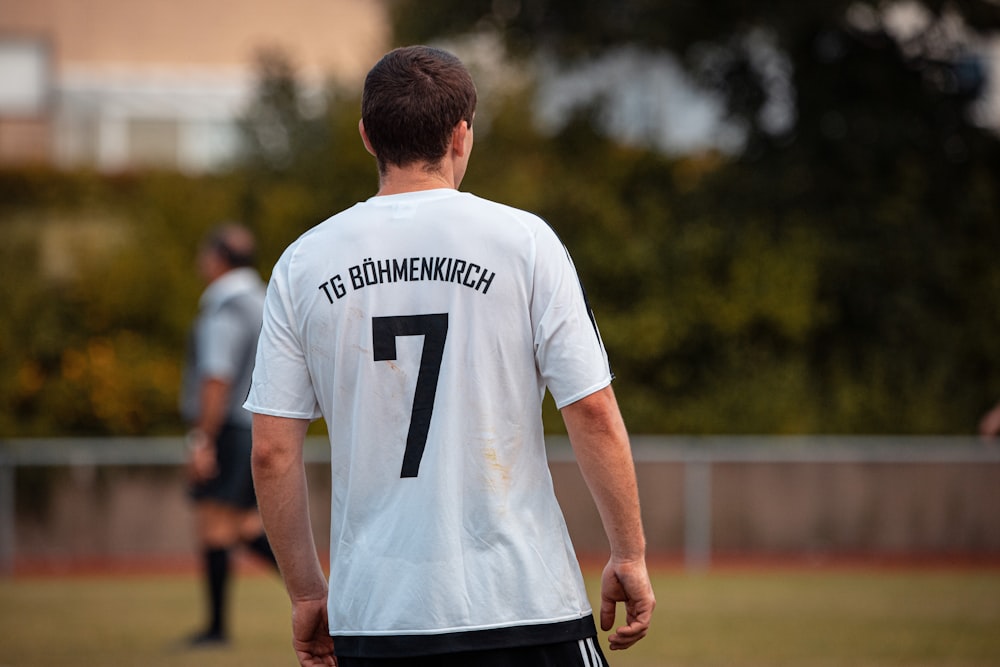 man in white and black crew neck t-shirt and black shorts