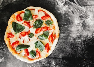 pizza with green leaf vegetable