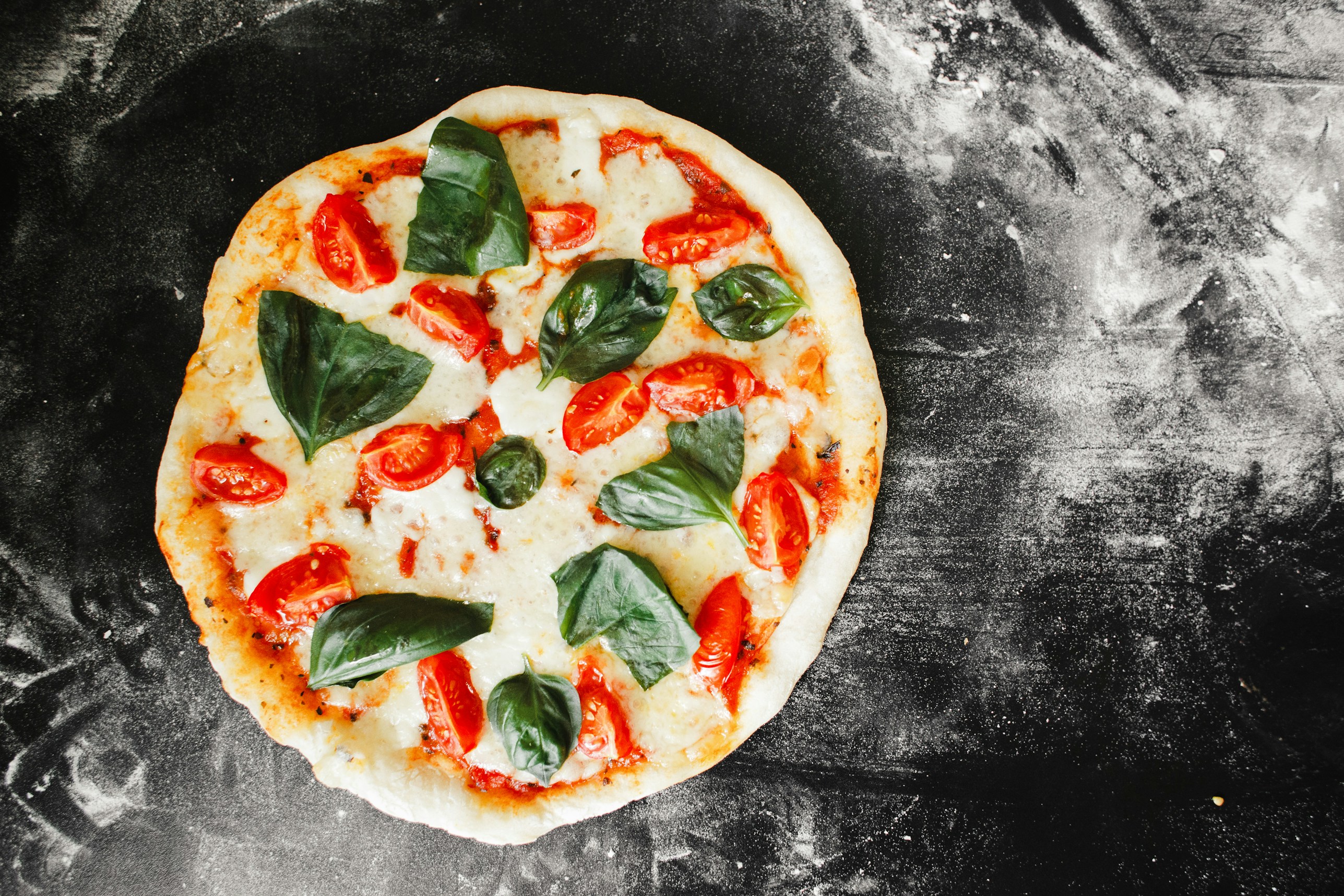 pizza with green leaf vegetable