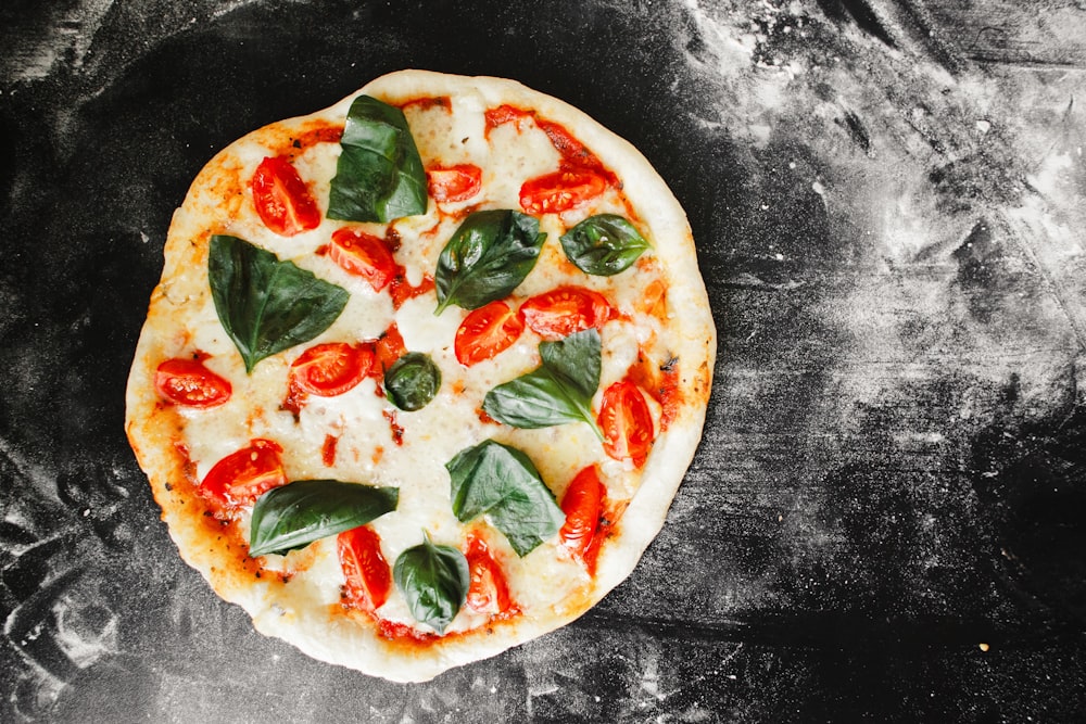 pizza with green leaf vegetable