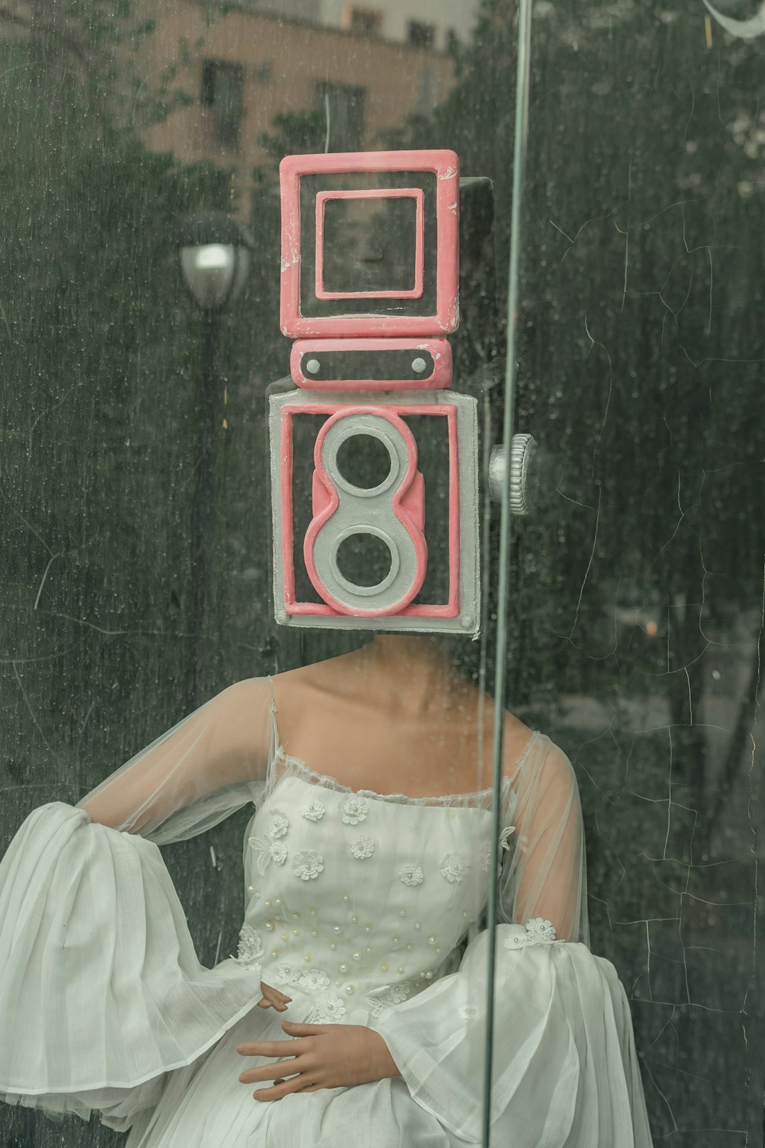 woman in white dress standing beside red and black speaker