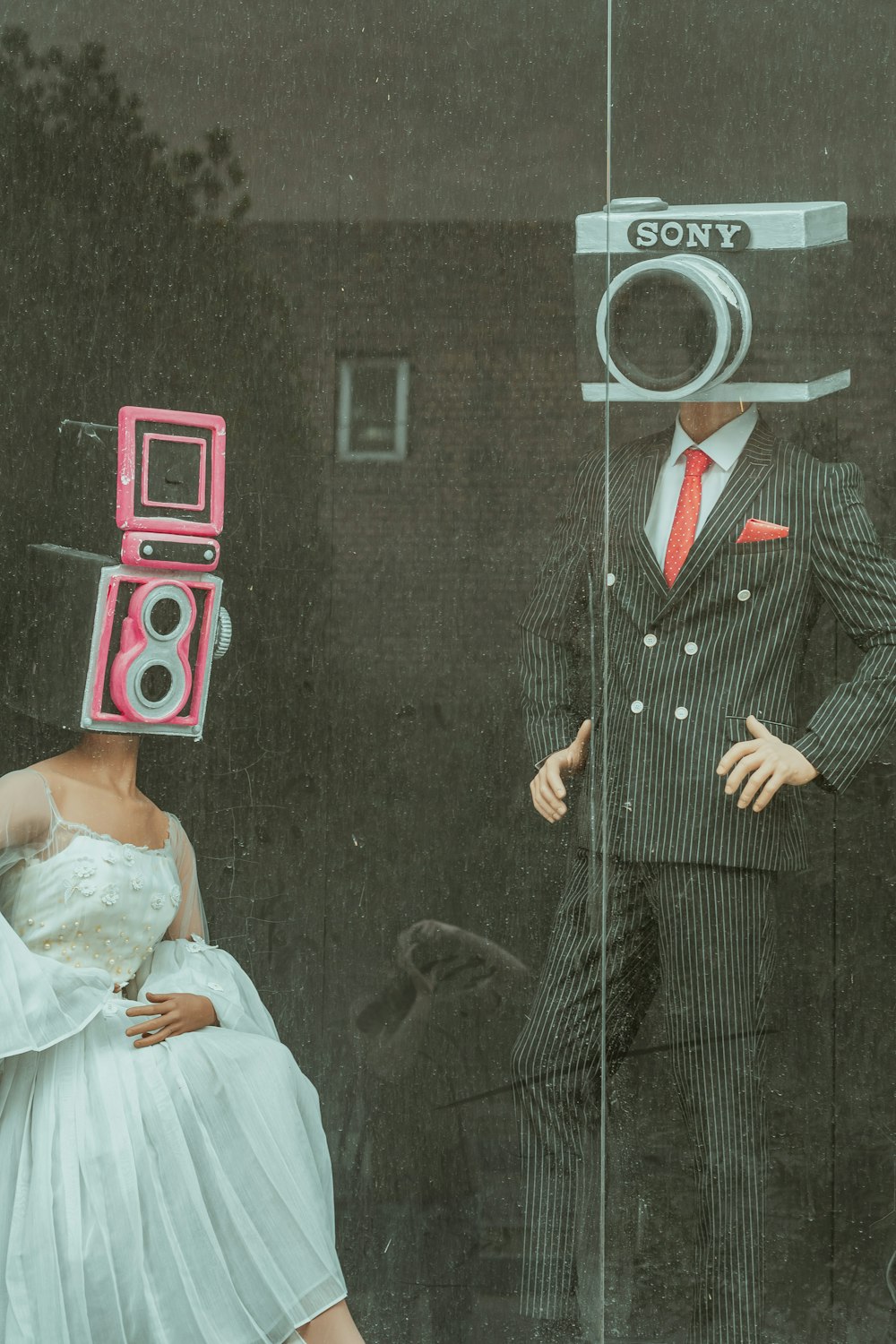 woman in white wedding dress holding red and white camera