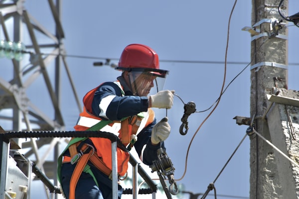 Electrician working on power pole