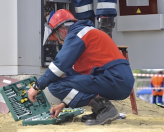 man in red and black jacket wearing black pants and red helmet holding green and black