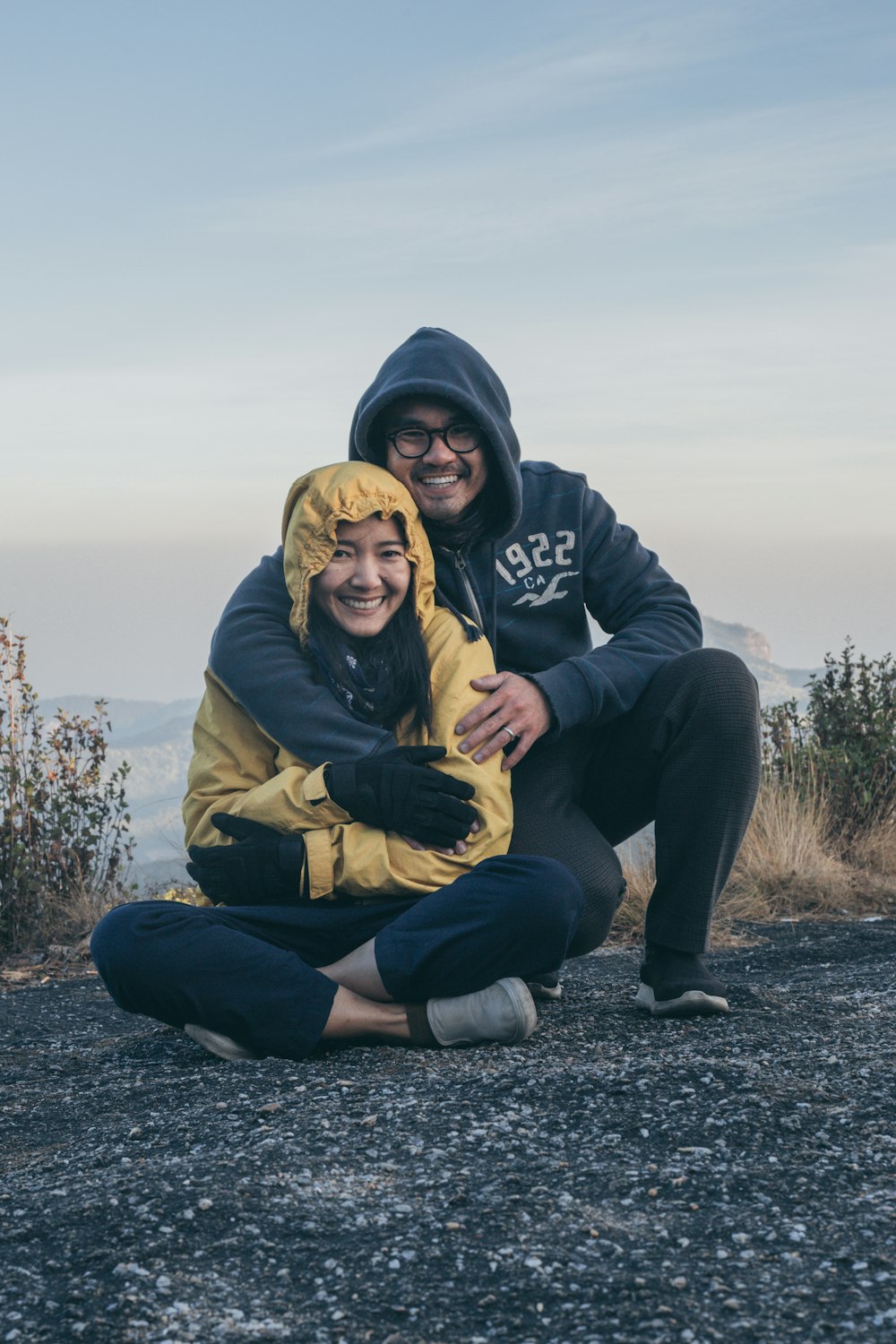 man and woman sitting on ground during daytime