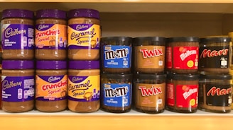 a shelf filled with lots of different types of peanut butter