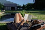 woman in black and white polka dot dress reading book