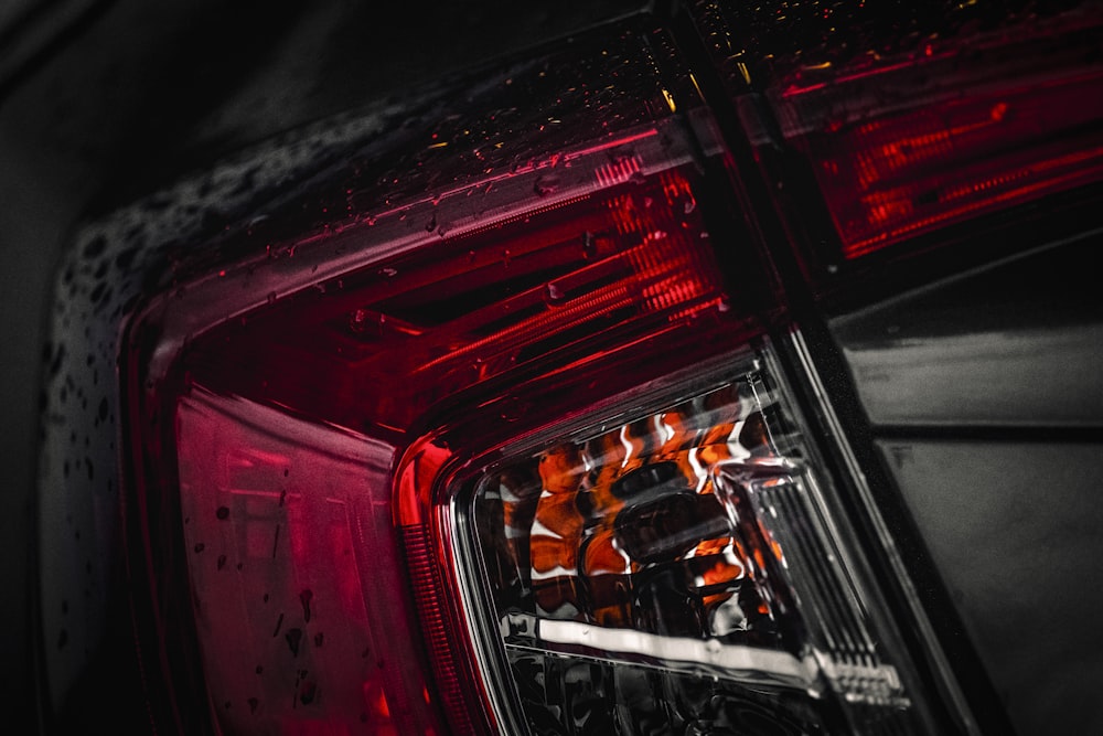 red and black car in the city during night time