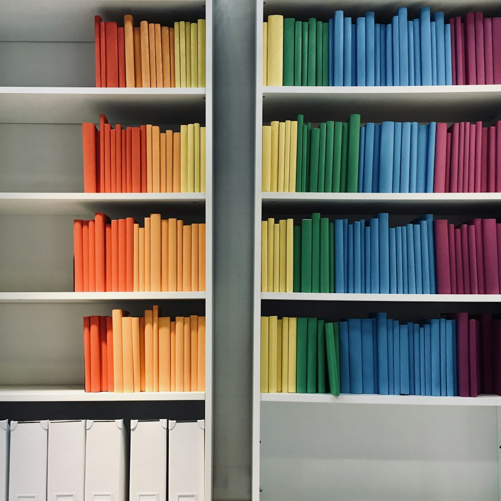 books on white wooden shelf