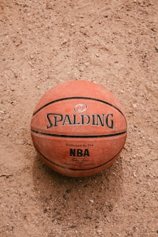 brown basketball on white sand