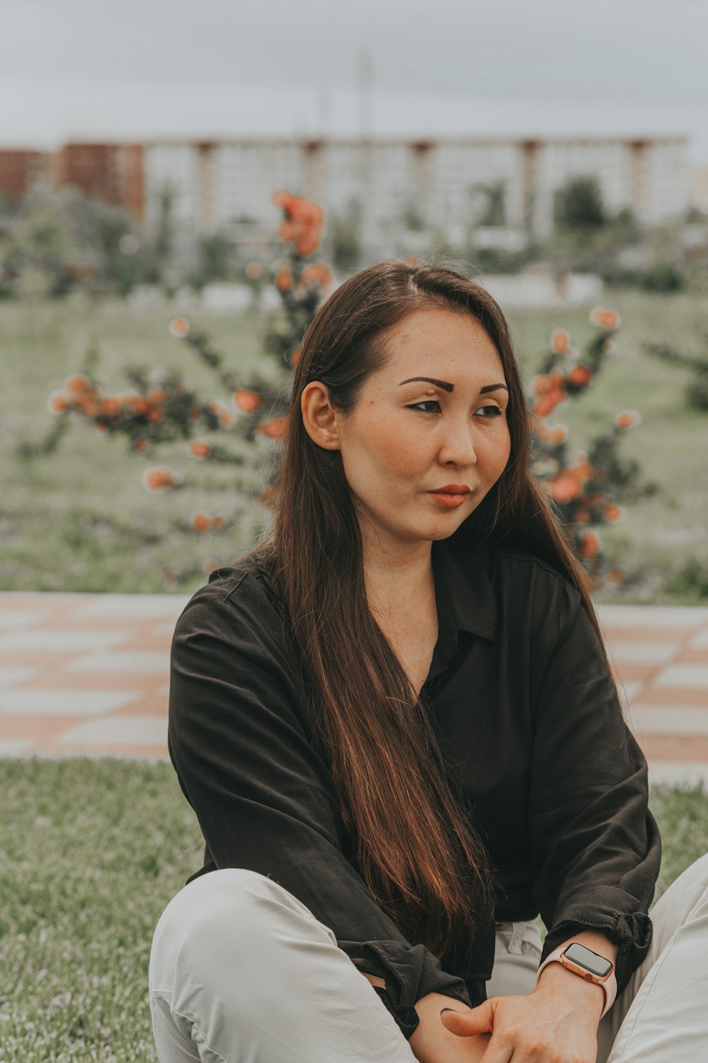 woman in black jacket standing on green grass field during daytime