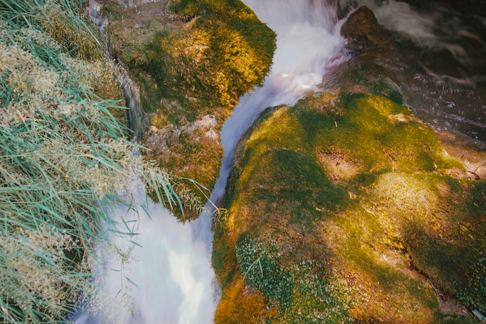 green grass covered mountain with water falls