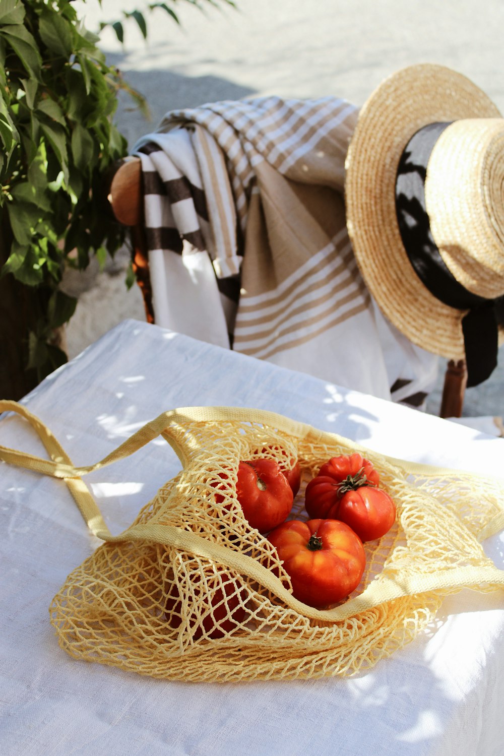 red tomato on brown woven basket