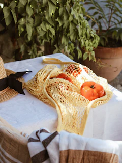White bucket hat with yellow accents placed on a sunny outdoor table