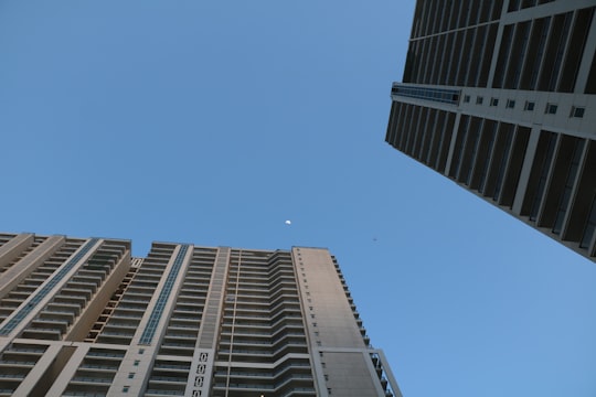 low angle photography of high rise buildings under blue sky during daytime in DLF Golf Course India
