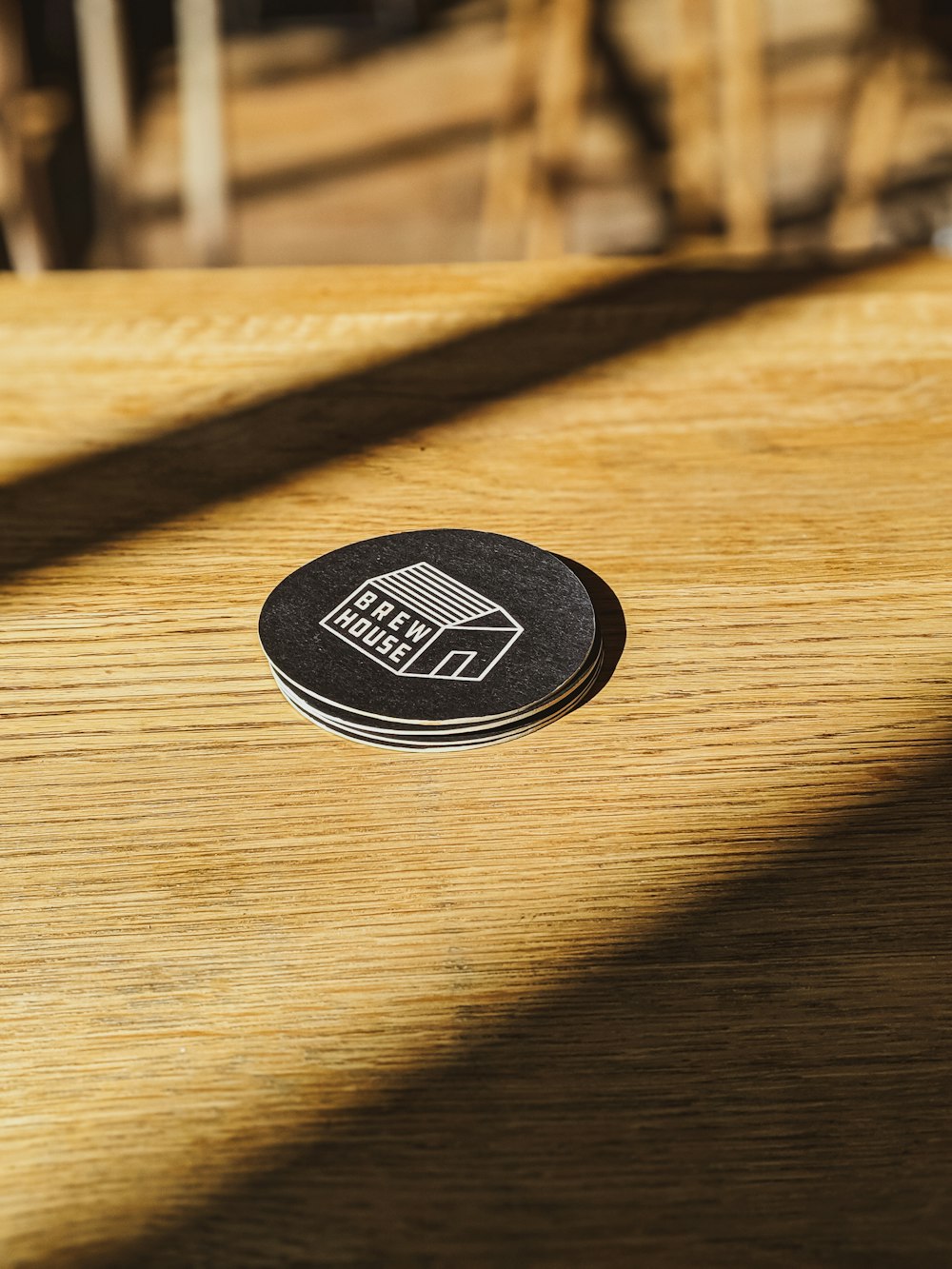 black and white round patch on brown wooden table