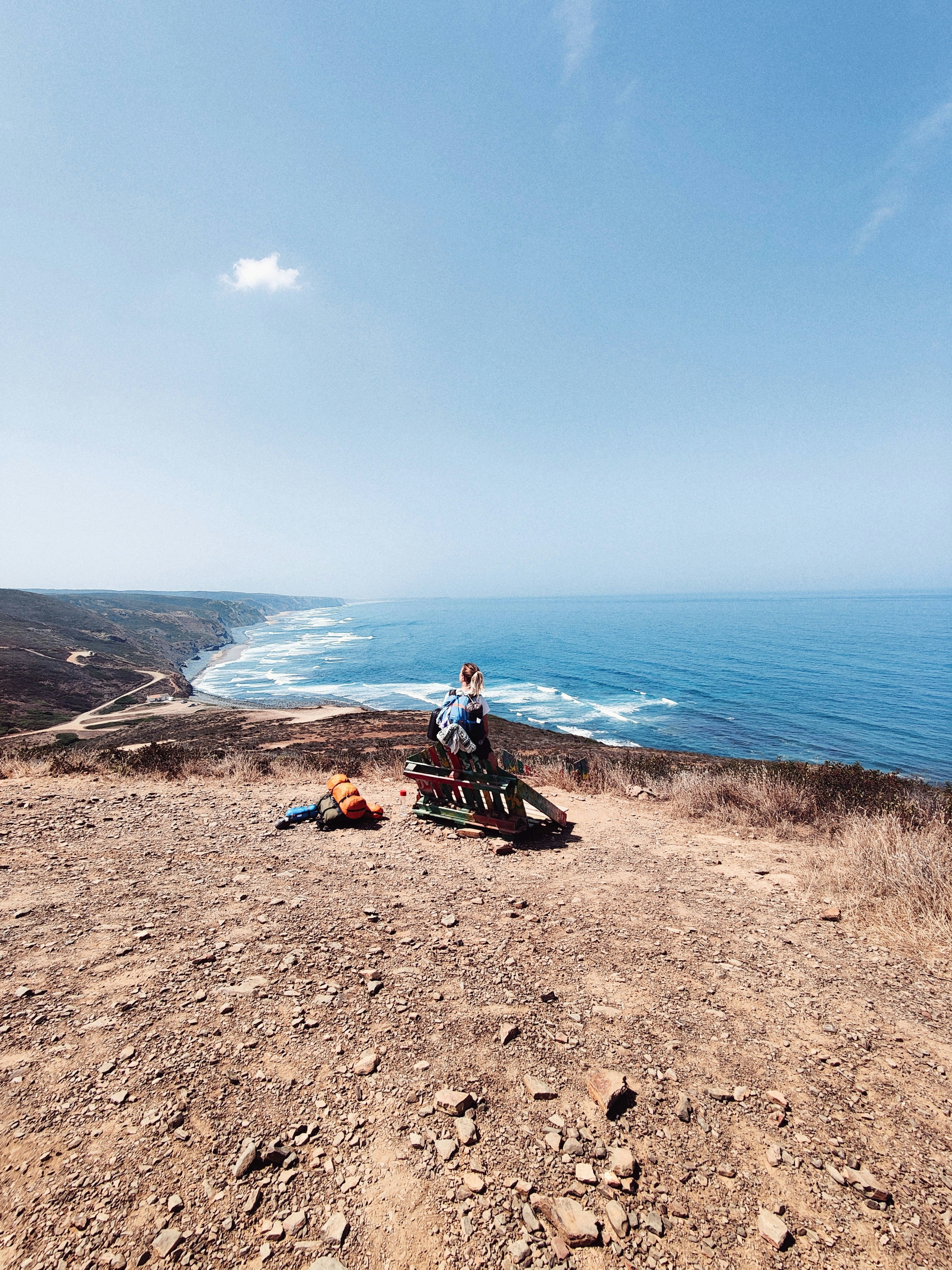 a couple of people sitting on top of a dirt hill