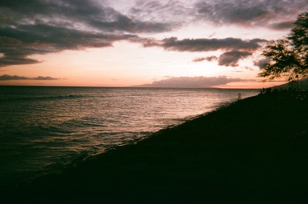 body of water under cloudy sky during daytime