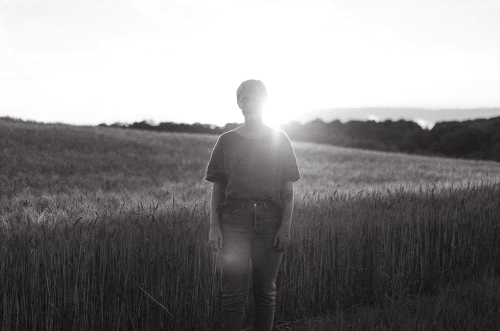 a man standing in a field of tall grass