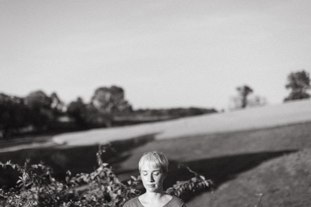 a black and white photo of a woman holding a skateboard