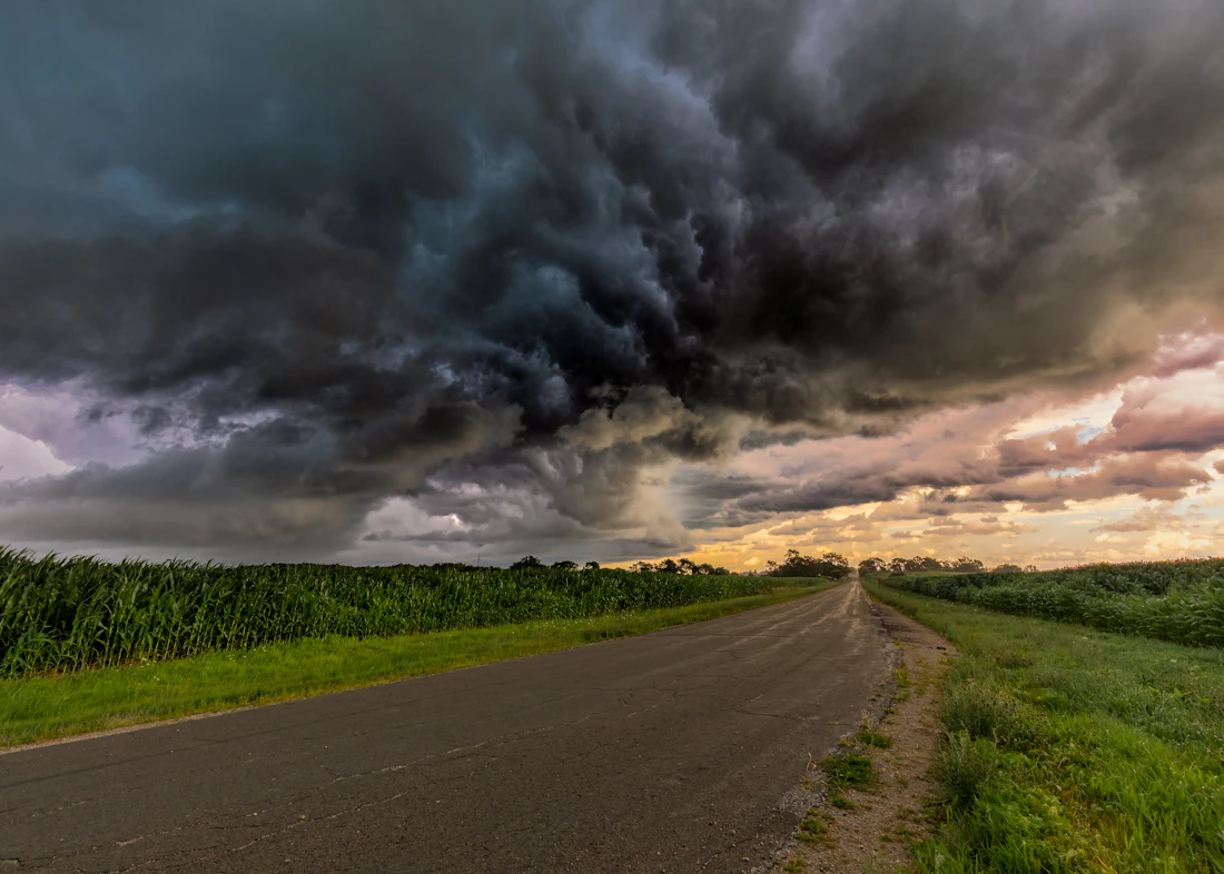 Gray storm clouds gathering over an open grass field