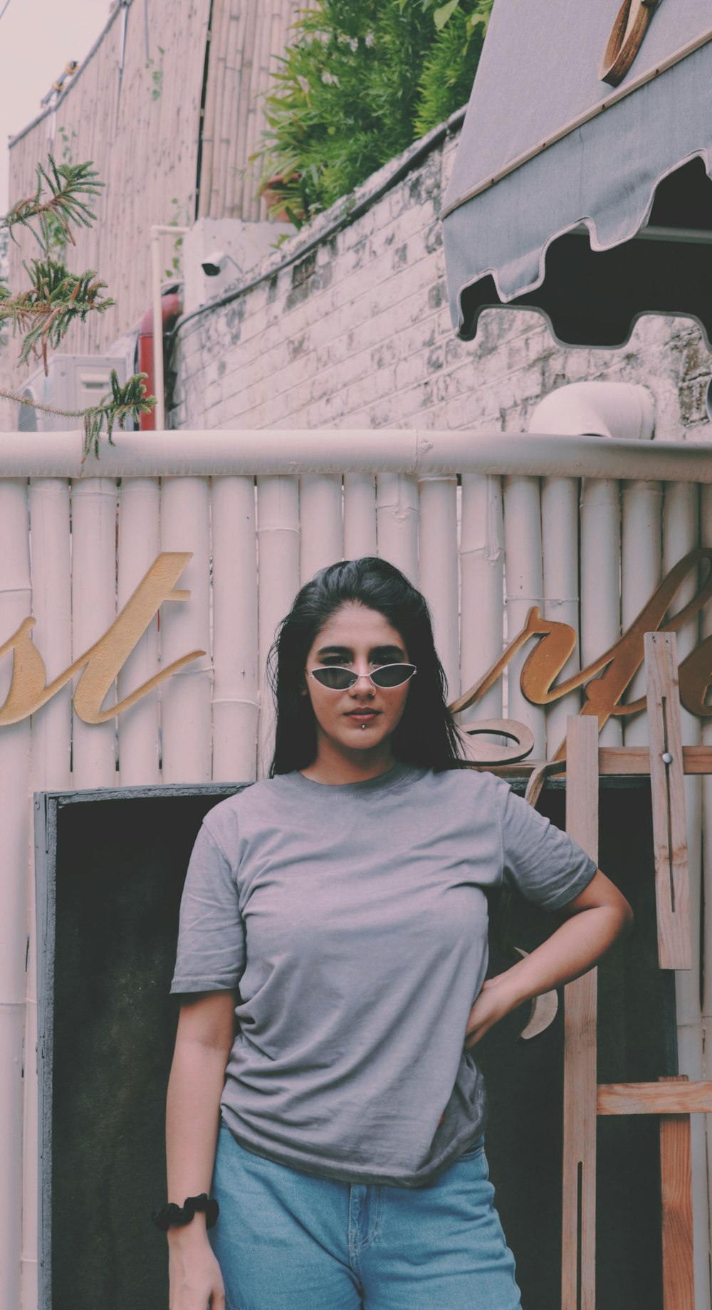 woman in gray crew neck t-shirt wearing black sunglasses