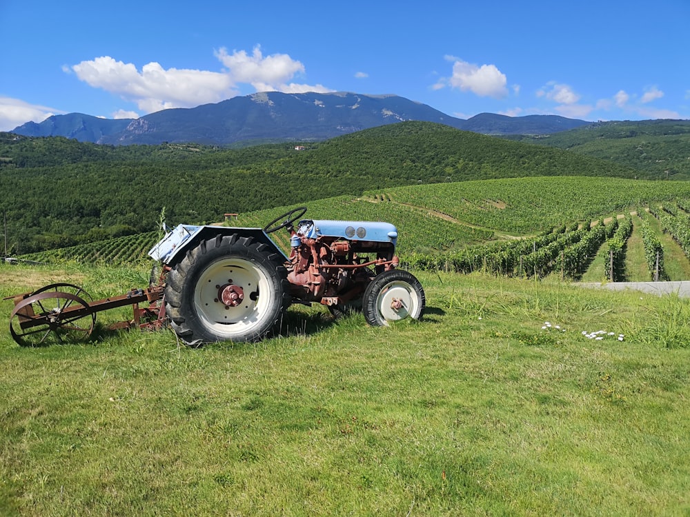 red tractor on green grass field during daytime