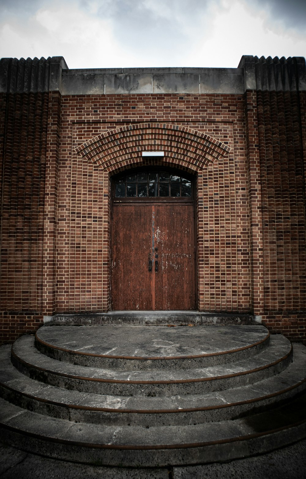 brown brick wall with brown wooden door