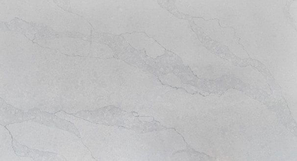 A smooth, polished surface with a light gray marble pattern. Subtle veins in a slightly darker shade run across the surface, adding an elegant texture to the stone.