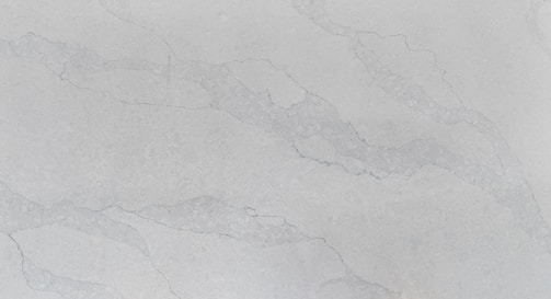 A smooth, polished surface with a light gray marble pattern. Subtle veins in a slightly darker shade run across the surface, adding an elegant texture to the stone.