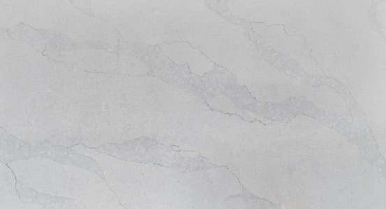 A smooth, polished surface with a light gray marble pattern. Subtle veins in a slightly darker shade run across the surface, adding an elegant texture to the stone.